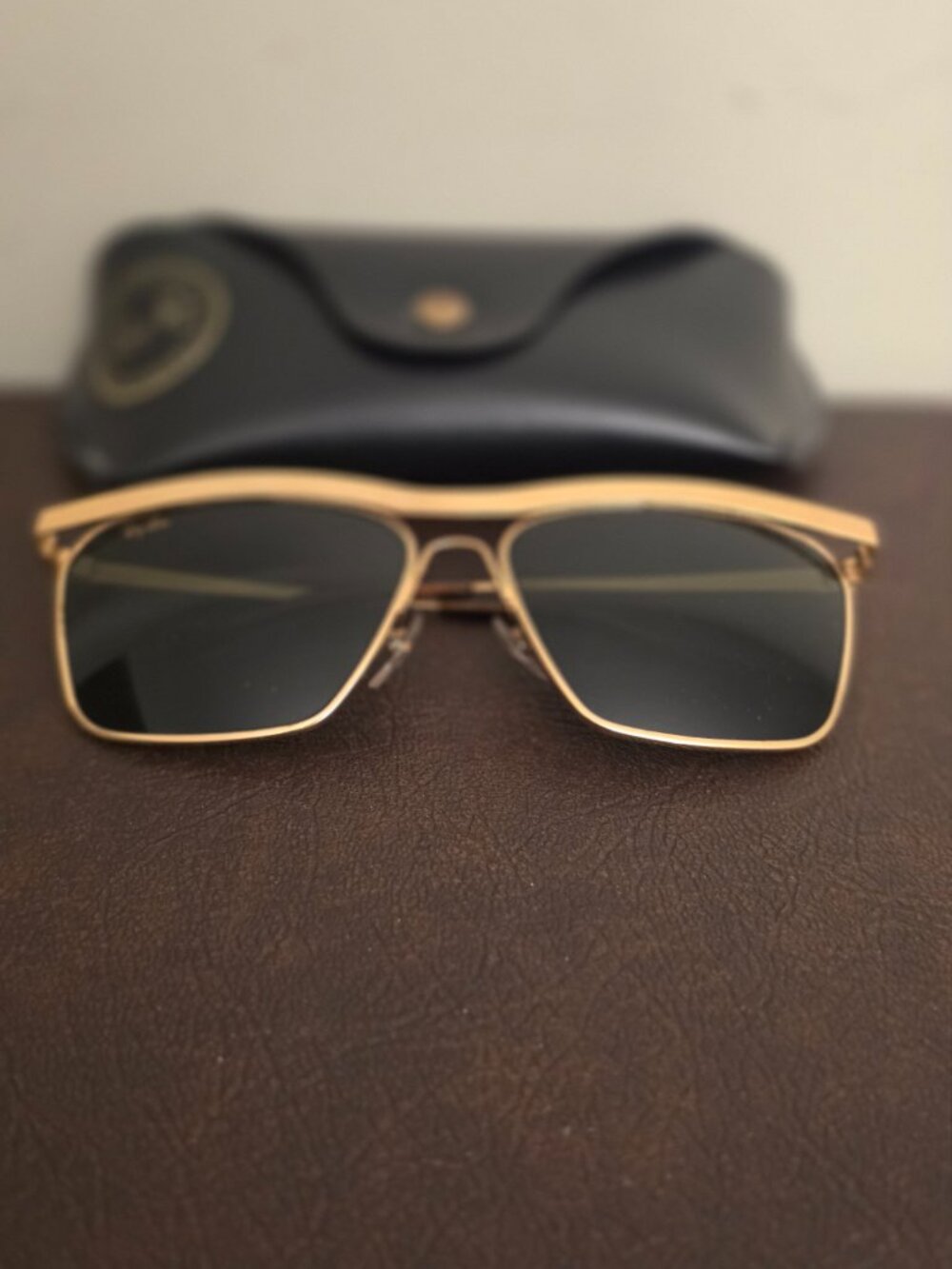 The Vintage Ray-Ban Sunglasses feature a classic gold metal frame with Olympian